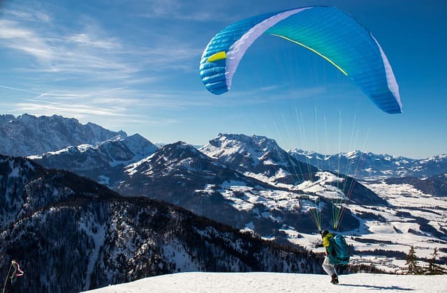 Paragliding over Manali valleys with panoramic Himalayan views, among the best places to visit in Manali Himachal Pradesh.