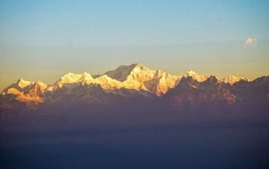 Golden sunrise at Tiger Hill with Himalayan peaks, highlighting iconic Darjeeling Sightseeing Places.
