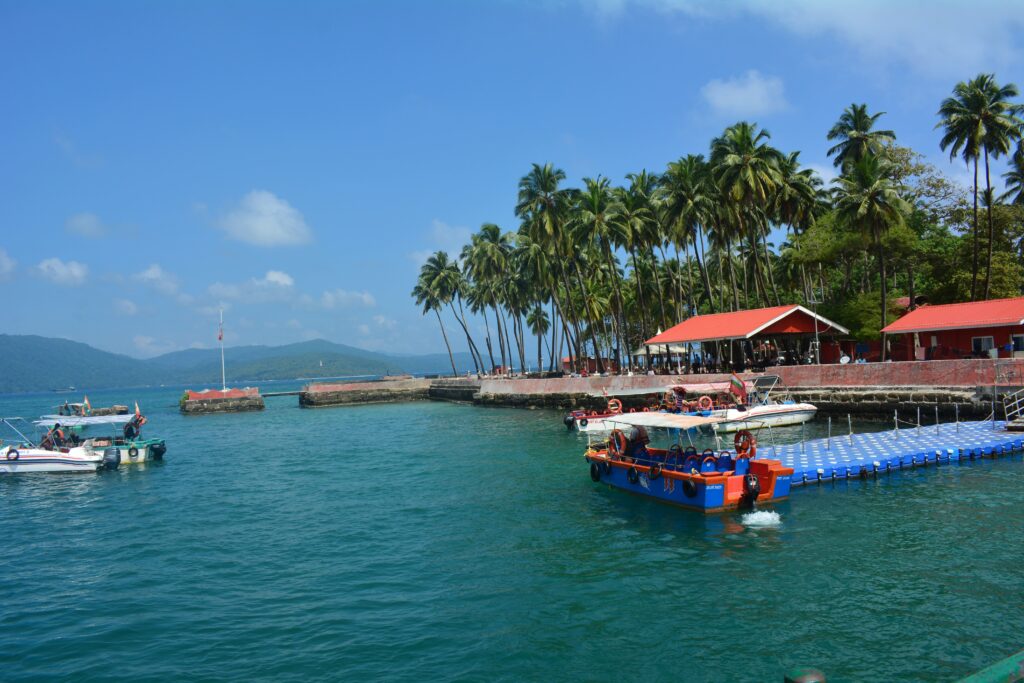 Travelers exploring the natural beauty and top tourist places in Andaman and Nicobar Islands surrounded by turquoise waters.