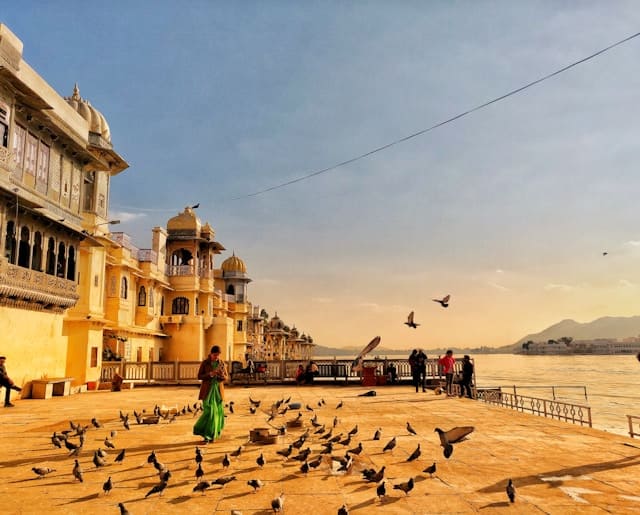 Visitors enjoying the peaceful atmosphere at Gangaur Ghat on Lake Pichola in Udaipur.